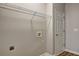 Neutral laundry room with white door, wire shelving and wood look flooring at 1620 Rising Mist Ln, Cumming, GA 30041