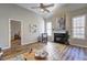 Spacious living room featuring a fireplace, hardwood floors, and a view into the adjacent bedroom at 1620 Rising Mist Ln, Cumming, GA 30041