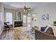 Bright living room with vaulted ceiling, fireplace, wood floors, and lots of natural light at 1620 Rising Mist Ln, Cumming, GA 30041