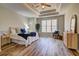 Spacious main bedroom with a tray ceiling, large window, and ample natural light at 1620 Rising Mist Ln, Cumming, GA 30041