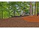 Community playground with a slide and climbing area in a natural setting at 1620 Rising Mist Ln, Cumming, GA 30041