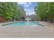 Community pool area with lounge chairs and nearby cabana-style pool house at 1620 Rising Mist Ln, Cumming, GA 30041