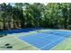 Well-maintained community tennis courts with vibrant blue and green surfaces at 1620 Rising Mist Ln, Cumming, GA 30041