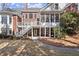 Spacious backyard with white staircases, exposed brick and white columns provides seamless indoor-outdoor living at 2758 Chieftain Run, Duluth, GA 30097