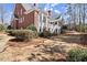 Manicured backyard with red brick facade, lush greenery, and classic architectural design at 2758 Chieftain Run, Duluth, GA 30097