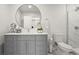 Contemporary bathroom with grey vanity, round mirror, and a glass-enclosed shower with white tiling at 2758 Chieftain Run, Duluth, GA 30097