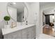 Bright bathroom featuring gray cabinets, a large mirror, and modern fixtures at 2758 Chieftain Run, Duluth, GA 30097