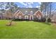 Beautiful single Gathering home with manicured lawn, mature landscaping and a brick facade at 2758 Chieftain Run, Duluth, GA 30097