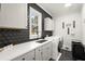 Modern laundry room featuring sleek cabinetry, a functional sink, and updated washer and dryer units at 2758 Chieftain Run, Duluth, GA 30097