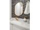 Stylish powder room with unique mosaic tiles, a modern gold faucet, and white marble countertop at 2758 Chieftain Run, Duluth, GA 30097