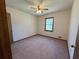 Cozy bedroom featuring neutral carpeting, a ceiling fan, and a bright window at 2917 High Brook Se Way, Conyers, GA 30094