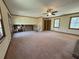 Expansive living room featuring neutral carpeting, large windows, and a view of the stairway at 2917 High Brook Se Way, Conyers, GA 30094