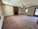 Spacious living room boasts a brick fireplace, large windows, and neutral carpeting at 2917 High Brook Se Way, Conyers, GA 30094