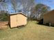 Tan storage shed located in the backyard at 2917 High Brook Se Way, Conyers, GA 30094