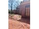 Brick home exterior with large boarded windows and visible under-construction landscaping at 4881 Powers Ferry Nw Rd, Atlanta, GA 30327