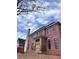 Two-story brick home featuring black-framed windows, chimney, and porch area awaiting finishing touches at 4881 Powers Ferry Nw Rd, Atlanta, GA 30327