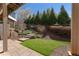 Landscaped backyard with stone patio and steps leading to upper garden at 700 Clubside Dr, Roswell, GA 30076