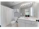 Bathroom featuring a white cabinet vanity, a toilet, and a shower with a gray wall color at 700 Clubside Dr, Roswell, GA 30076