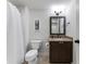 Bathroom featuring a toilet, vanity with storage, and a shower behind a white shower curtain at 700 Clubside Dr, Roswell, GA 30076