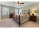 Cozy bedroom featuring natural light, and neutral colored walls and carpet with a metal bed frame at 700 Clubside Dr, Roswell, GA 30076