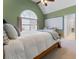 Bedroom with high ceilings, arched window, desk and view to the en suite bathroom at 700 Clubside Dr, Roswell, GA 30076