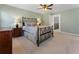 Comfortable bedroom featuring a metal bed frame, a ceiling fan, neutral walls, and carpet floors at 700 Clubside Dr, Roswell, GA 30076