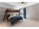 Bedroom with bunk beds, a ceiling fan, and large window with blinds and blue curtains at 700 Clubside Dr, Roswell, GA 30076