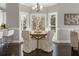 Bright breakfast nook featuring a round table, upholstered chairs, and large bay windows at 700 Clubside Dr, Roswell, GA 30076