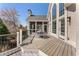 Spacious outdoor deck with dining area overlooking the private backyard and the home's screened-in porch at 700 Clubside Dr, Roswell, GA 30076