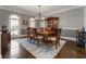 Dining room with hardwood floors, chandelier, and large area rug at 700 Clubside Dr, Roswell, GA 30076