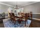 Dining room featuring hardwood floors, chandelier, and large area rug at 700 Clubside Dr, Roswell, GA 30076