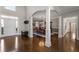 Open foyer with wood floors and columns leading into dining room at 700 Clubside Dr, Roswell, GA 30076