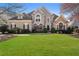 Attractive front exterior of a two story home with a well-manicured lawn and mature landscaping at 700 Clubside Dr, Roswell, GA 30076