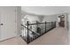 Upstairs hallway with carpeted floors, dark wood banister, and views to living room and bedroom at 700 Clubside Dr, Roswell, GA 30076