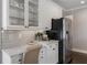 Kitchen featuring white cabinetry, stainless steel appliances, and a built-in desk area at 700 Clubside Dr, Roswell, GA 30076