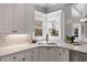 Kitchen corner sink with white countertops and subway tile backsplash at 700 Clubside Dr, Roswell, GA 30076