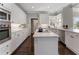 Modern white kitchen with stainless appliances and a center island at 700 Clubside Dr, Roswell, GA 30076