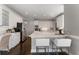 Modern kitchen with stainless steel appliances, white cabinetry, and barstool seating at the island at 700 Clubside Dr, Roswell, GA 30076