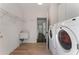 Laundry room with a sink, shelving, a side-by-side washer and dryer, and wood-look flooring at 700 Clubside Dr, Roswell, GA 30076