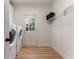 Bright laundry room featuring a side-by-side washer and dryer and a door with window panes at 700 Clubside Dr, Roswell, GA 30076