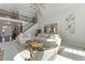 Sunlit living room with a two-story staircase, neutral colors, and a cozy seating area at 700 Clubside Dr, Roswell, GA 30076