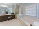 Main bathroom featuring a shower, bath tub, and large mirror above the vanity at 700 Clubside Dr, Roswell, GA 30076