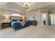 Bright main bedroom with neutral colors, carpet, and an arched window above the headboard at 700 Clubside Dr, Roswell, GA 30076