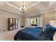 Main bedroom featuring a large bed, mirrored dresser, and doors to the outdoor living space at 700 Clubside Dr, Roswell, GA 30076