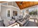 Cozy sunroom with vaulted ceiling, wood accents, and patio furniture at 700 Clubside Dr, Roswell, GA 30076