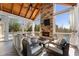 Inviting sunroom with a stone fireplace, wood ceiling, and comfortable seating area at 700 Clubside Dr, Roswell, GA 30076