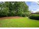 Well-manicured backyard with lush green grass and mature trees at 1976 Hedge Brooke Nw Trl, Acworth, GA 30101
