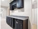 Basement bar area with dark cabinets, granite countertop, and wine rack at 1976 Hedge Brooke Nw Trl, Acworth, GA 30101