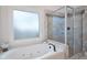 Modern tub and shower with tile surround and glass door at 1976 Hedge Brooke Nw Trl, Acworth, GA 30101