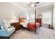 Bright bedroom featuring a four-poster bed, ceiling fan, and carpeted floors at 1976 Hedge Brooke Nw Trl, Acworth, GA 30101